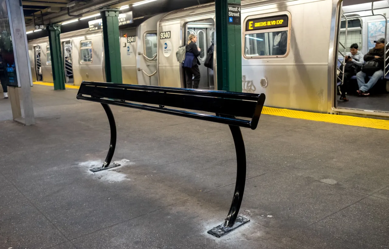 Leaning bar replacing bench at transit station